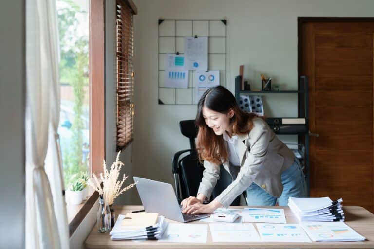 financial, Planning, Marketing and Accounting, portrait of Asian employee checking financial statements using documents and computer laptop at work