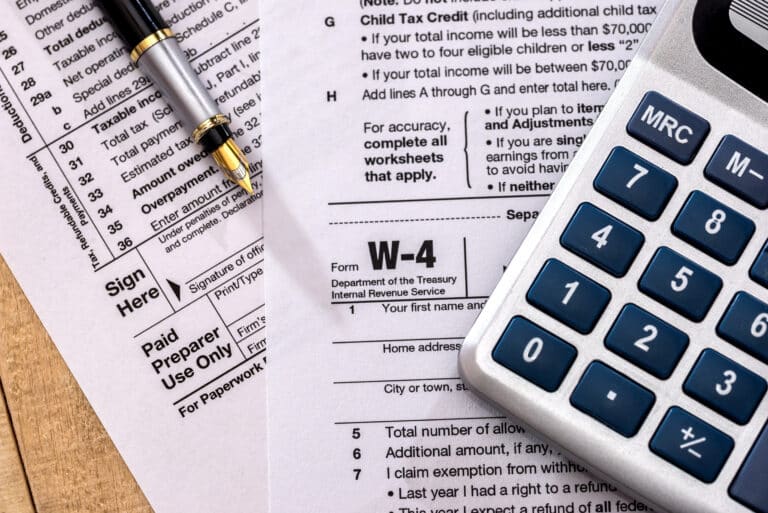 tax form w 4 with calculator and pen